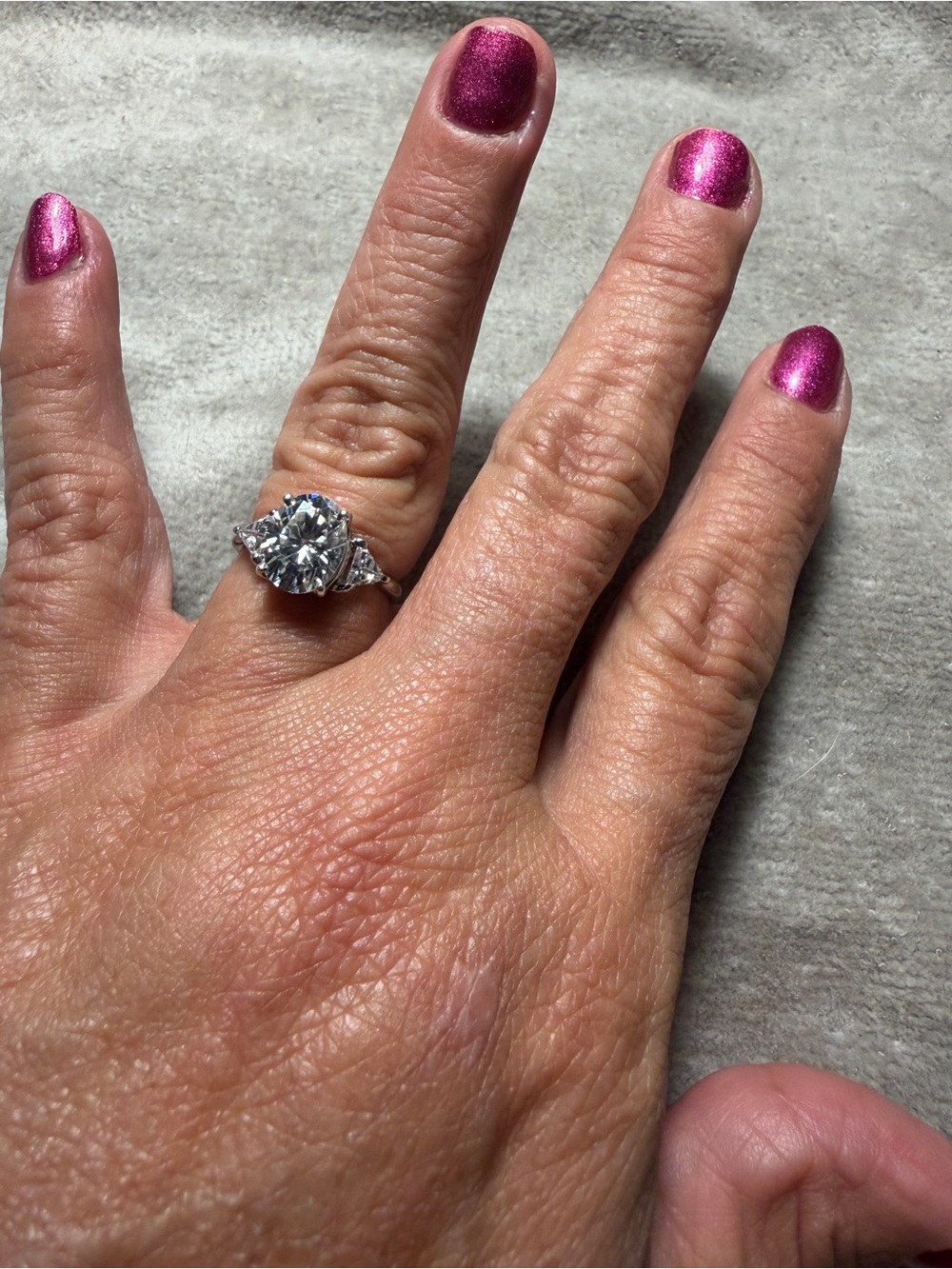 Stunning 2 carat moissanite diamond ring with trillion cut side stones.